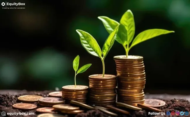 Young plants growing from stacks of coins in soil