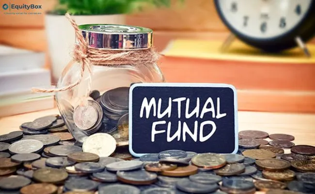 A glass jar of coins beside a sign reading “Mutual Fund”